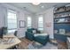 Inviting office space featuring a stylish chaise lounge, built-in shelving, and natural light from the large windows at 436 Ripple Park Dr, Summerville, SC 29486