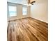 Bedroom featuring wood flooring, two windows and ceiling fan at 4816 Cane Pole Ln, Summerville, SC 29485