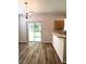Bright dining area with laminate flooring, view to a patio, and open to the kitchen at 4816 Cane Pole Ln, Summerville, SC 29485