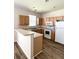 Inviting kitchen with a breakfast bar, wood cabinetry, and easy-to-clean laminate floors at 4816 Cane Pole Ln, Summerville, SC 29485