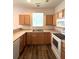 Bright kitchen with spacious countertops, white appliances, and warm wood cabinets at 4816 Cane Pole Ln, Summerville, SC 29485