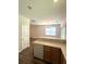 View of the kitchen with a bar and cabinets and leading to a dining area with natural light at 4816 Cane Pole Ln, Summerville, SC 29485