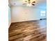 Open-concept living room with laminate flooring, fan, and a minimalist design at 4816 Cane Pole Ln, Summerville, SC 29485
