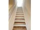 Staircase featuring modern wood-look steps and white risers at 4816 Cane Pole Ln, Summerville, SC 29485