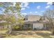 Spacious backyard with a screened porch, lush greenery, and exterior utilities neatly organized at 4850 Habersham Ln, Summerville, SC 29485
