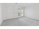 A bright, carpeted bedroom with double doors leading to a balcony or patio at 4850 Habersham Ln, Summerville, SC 29485