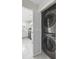 Modern laundry area with stackable washer and dryer units and white cabinetry in the background at 4850 Habersham Ln, Summerville, SC 29485