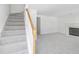 Cozy living area with a fireplace, neutral carpeting, and a staircase to the upper level at 4850 Habersham Ln, Summerville, SC 29485