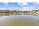 Scenic view of a pond surrounded by homes, with a fountain in the center at 4850 Habersham Ln, Summerville, SC 29485
