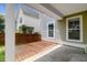 This covered back patio features both wood and concrete, offering plenty of space for entertaining at 5242 E Dolphin St, North Charleston, SC 29405