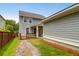 Backyard with wooden deck, stone pathway, and mature landscaping offering privacy and charm at 5242 E Dolphin St, North Charleston, SC 29405