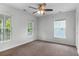 Bedroom featuring neutral walls, carpet, a ceiling fan and multiple windows at 5242 E Dolphin St, North Charleston, SC 29405