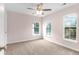 Bedroom with carpet, neutral walls, a ceiling fan and two windows at 5242 E Dolphin St, North Charleston, SC 29405
