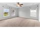 Bright, spacious bedroom with large windows and ceiling fan offers ample natural light at 5242 E Dolphin St, North Charleston, SC 29405