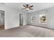 Spacious primary bedroom features carpet, natural light from 2 windows, a ceiling fan and ensuite bath at 5242 E Dolphin St, North Charleston, SC 29405