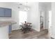 Cozy dining area featuring modern table and chairs, adjacent to kitchen and powder room at 5242 E Dolphin St, North Charleston, SC 29405