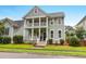 Charming two-story home featuring a double porch, manicured lawn, and inviting curb appeal at 5242 E Dolphin St, North Charleston, SC 29405