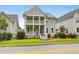 Attractive two-story home with a double porch, showcasing classic architectural design and landscaping at 5242 E Dolphin St, North Charleston, SC 29405