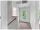 Upstairs hallway with neutral colored walls and carpet, and door leading to a balcony at 5242 E Dolphin St, North Charleston, SC 29405