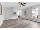 Spacious living room with light wood floors, ceiling fan, and dining area, offering ample space for entertaining at 5242 E Dolphin St, North Charleston, SC 29405