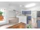 Open floor plan featuring living, dining and kitchen area with blue cabinets and stainless steel appliances at 5242 E Dolphin St, North Charleston, SC 29405