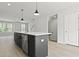 Open-concept kitchen with stainless appliances, island with breakfast bar, and pendant lighting at 564 Scholar Way, Summerville, SC 29486