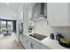 Close-up of a well-lit kitchen featuring white cabinets, stainless steel appliances, and minimalist design at 568 Scholar Way, Summerville, SC 29486