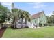 Backyard featuring a patio, deck, palm trees, green siding and a lush, green lawn at 591 Two Mile, Johns Island, SC 29455