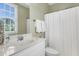 Bright bathroom with a vanity, a large mirror, and a shower-tub combination, offering a clean and functional space at 591 Two Mile, Johns Island, SC 29455