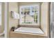 Bright bathroom features a soaking tub, neutral color scheme and natural light at 591 Two Mile, Johns Island, SC 29455