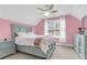 Charming bedroom with pink walls, natural light, and elegant furniture, creating a cozy and inviting atmosphere at 591 Two Mile, Johns Island, SC 29455