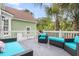 Outdoor deck featuring wicker furniture with turquoise cushions and palm trees providing shade at 591 Two Mile, Johns Island, SC 29455