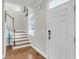Bright foyer featuring hardwood floors, a staircase, and a white front door with modern hardware at 591 Two Mile, Johns Island, SC 29455