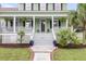 Charming two-story home with a welcoming porch, stairs leading to the front door, and well-maintained landscaping at 591 Two Mile, Johns Island, SC 29455