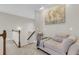 Cozy upstairs hallway nook with neutral decor, a comfortable chaise lounge, and a stylish world map art piece at 591 Two Mile, Johns Island, SC 29455