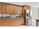 A kitchen featuring wood cabinets, granite countertops, and stainless steel refrigerator at 591 Two Mile, Johns Island, SC 29455