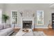 Cozy living room featuring a fireplace with marble surround, hardwood floors, and a decorative accent piece at 591 Two Mile, Johns Island, SC 29455