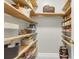 Organized pantry with natural wood shelving, offering plenty of storage for food and kitchen essentials at 591 Two Mile, Johns Island, SC 29455