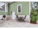Outdoor patio with dining table and chairs with an exterior door, window and green siding at 591 Two Mile, Johns Island, SC 29455