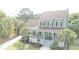 Charming two-story home with a spacious front porch and beautiful landscaping, perfect for relaxing and enjoying the outdoors at 591 Two Mile Run, Johns Island, SC 29455