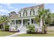 Inviting two-story home with a large front porch and lush landscaping, blending comfort with Southern charm at 591 Two Mile Run, Johns Island, SC 29455