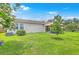 Spacious backyard with green lawn, patio and an outdoor dining set at 605 Grassy Hill Rd, Summerville, SC 29483