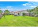 Wide backyard featuring a covered patio with dining set and a well-maintained green lawn at 605 Grassy Hill Rd, Summerville, SC 29483