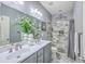 Bathroom featuring double sinks, large mirror, and tiled shower at 605 Grassy Hill Rd, Summerville, SC 29483