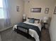 Carpeted bedroom featuring a cozy bed with stylish bedding and side tables with lamps at 605 Grassy Hill Rd, Summerville, SC 29483