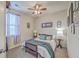 Cozy bedroom featuring a ceiling fan, a window with curtains, and a comfortable bed at 605 Grassy Hill Rd, Summerville, SC 29483
