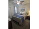Cozy bedroom with comfortable bed, ceiling fan, and bedside table with lamp at 605 Grassy Hill Rd, Summerville, SC 29483