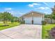 Attractive home featuring a two-car garage and a concrete driveway with well-manicured lawn at 605 Grassy Hill Rd, Summerville, SC 29483