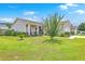 Charming home featuring a well-manicured front yard with green grass, shrubs and ornamental trees at 605 Grassy Hill Rd, Summerville, SC 29483