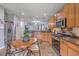 Bright kitchen with wooden cabinets, stainless steel appliances, and a cozy dining table at 605 Grassy Hill Rd, Summerville, SC 29483